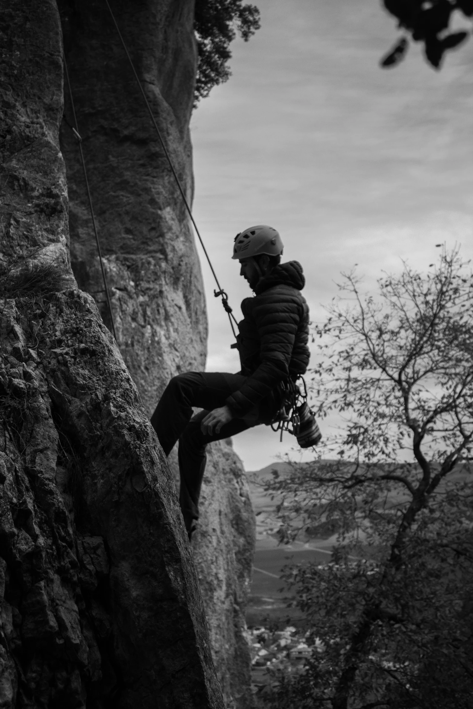 a person climbing up the side of a mountain