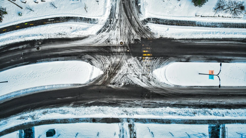 an overhead view of snow covered roads and signs