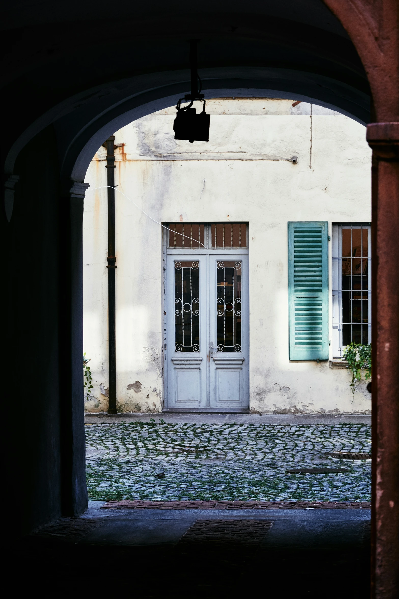 an arched doorway leads to a small entrance