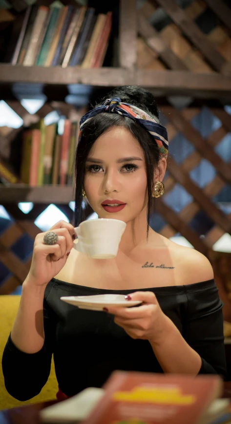 a woman holding a coffee cup and looking to the side