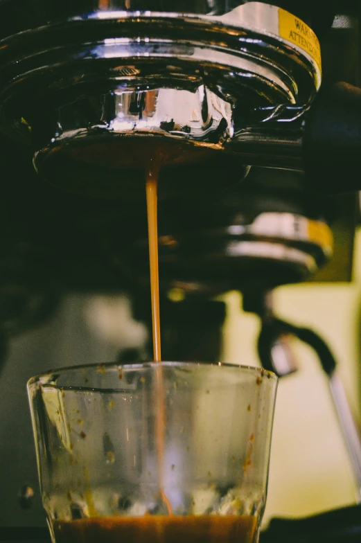 an espresso machine that is being used to fill up coffee beans