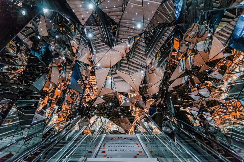 an escalator inside a modern building with mirror walls