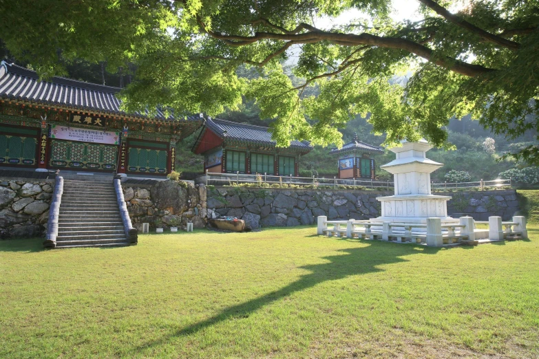 a large stone structure next to a small grassy yard