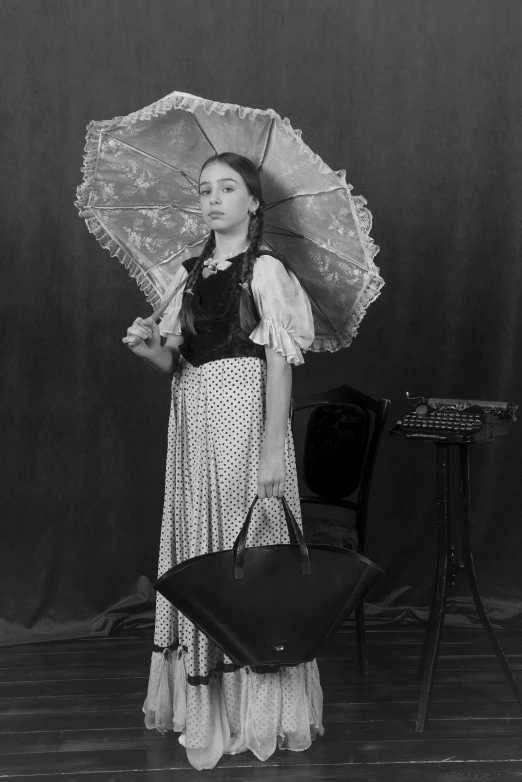 a black and white image of a woman holding an umbrella