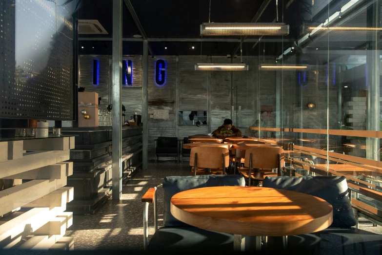 the interior of an indoor restaurant with wood and glass