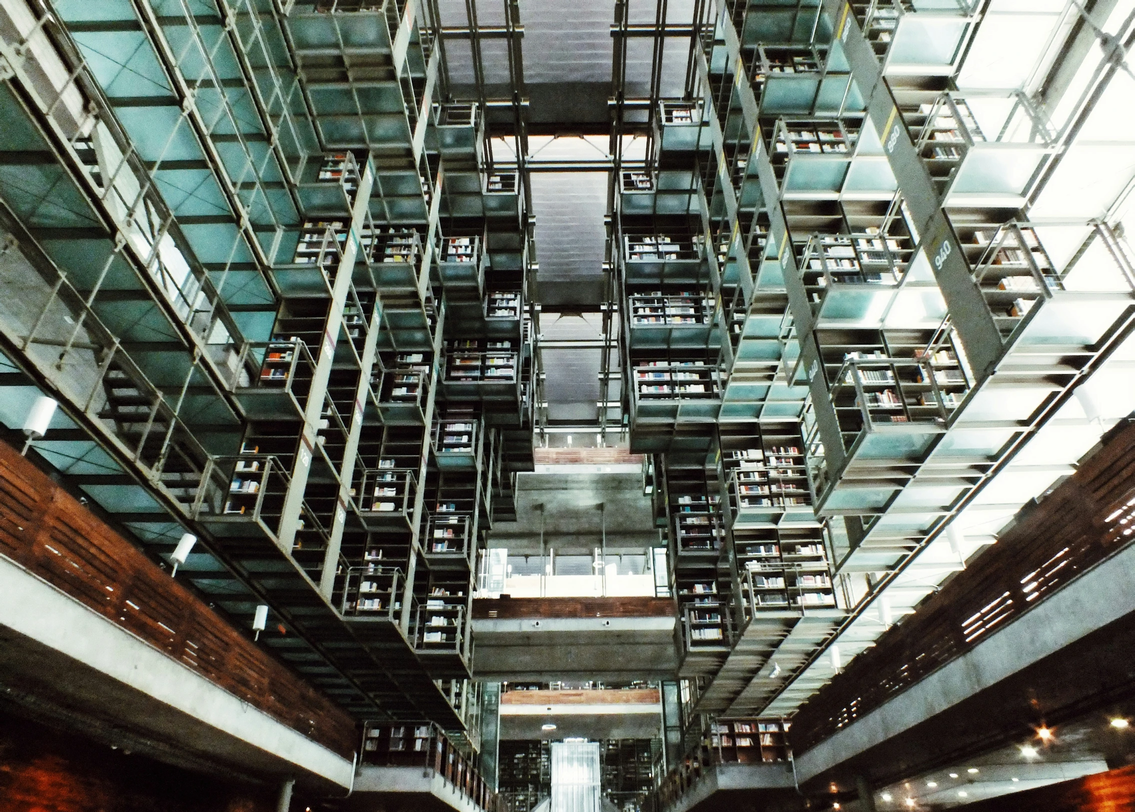 a large building with glass walls and metal balconies