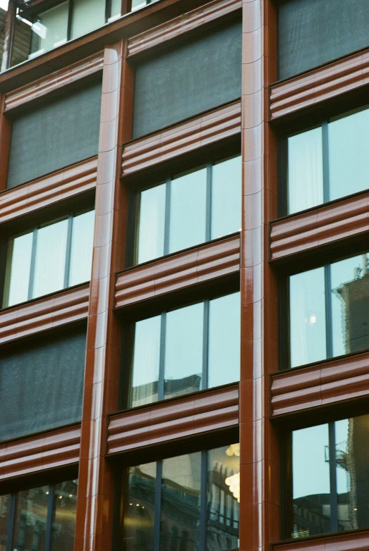 the reflection of a building with many windows