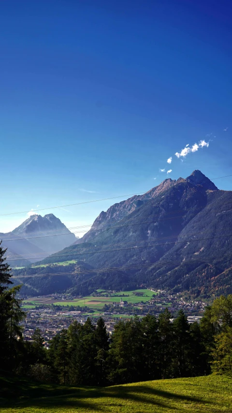 an aerial view of some mountain range with a city