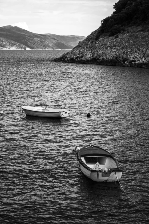 two small boats are sitting near the shoreline