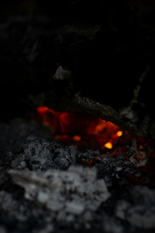 a fire lit up with small flames on the ground