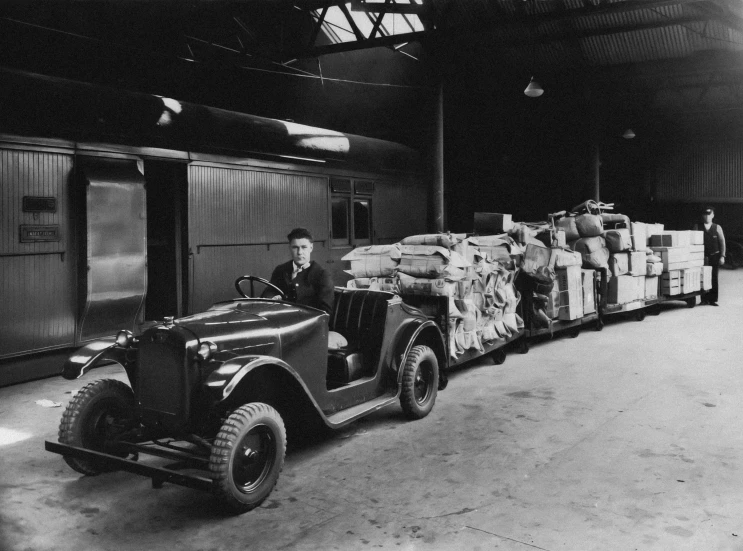 an old black and white image of a person sitting on top of a truck