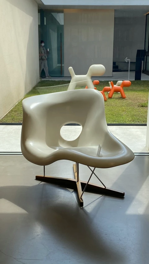 a white chair with two legs is seen in front of an open space
