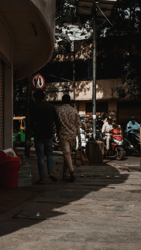 a couple of people walking down the street with suitcases