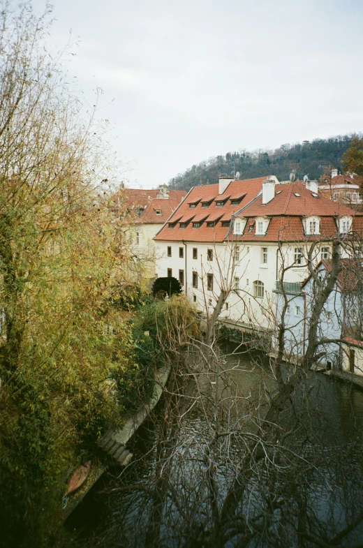 the buildings on the side of the river are built in old fashioned style