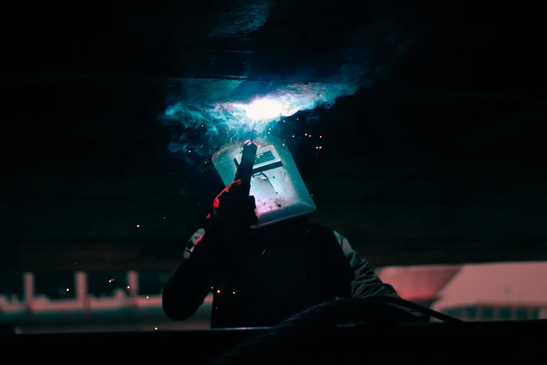 the worker is using a grinder to grind an object