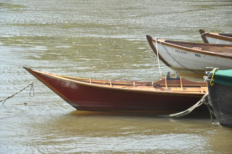 three rowboats are in the middle of a body of water