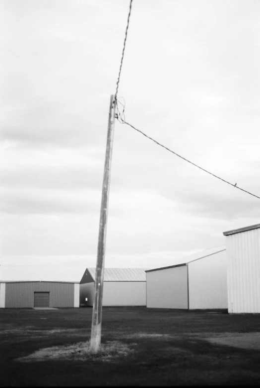 a stop sign stands in front of two tall white buildings