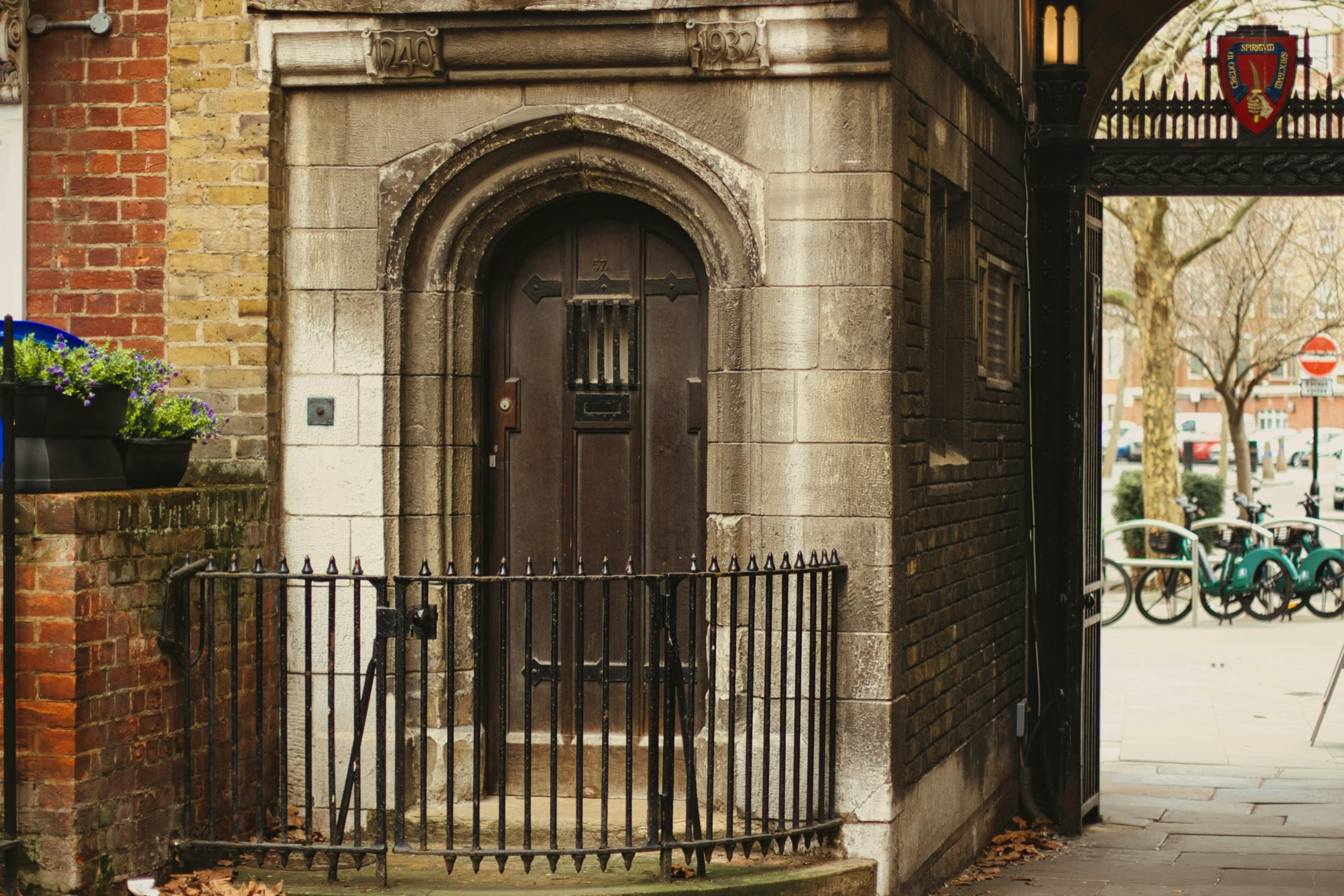 the view of an entrance to an alleyway from between two buildings