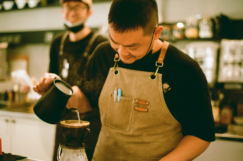 the man is stirring soing in the large glass