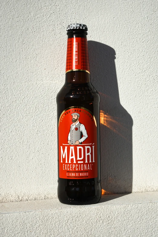 a brown bottle of mardi gras on a white wall