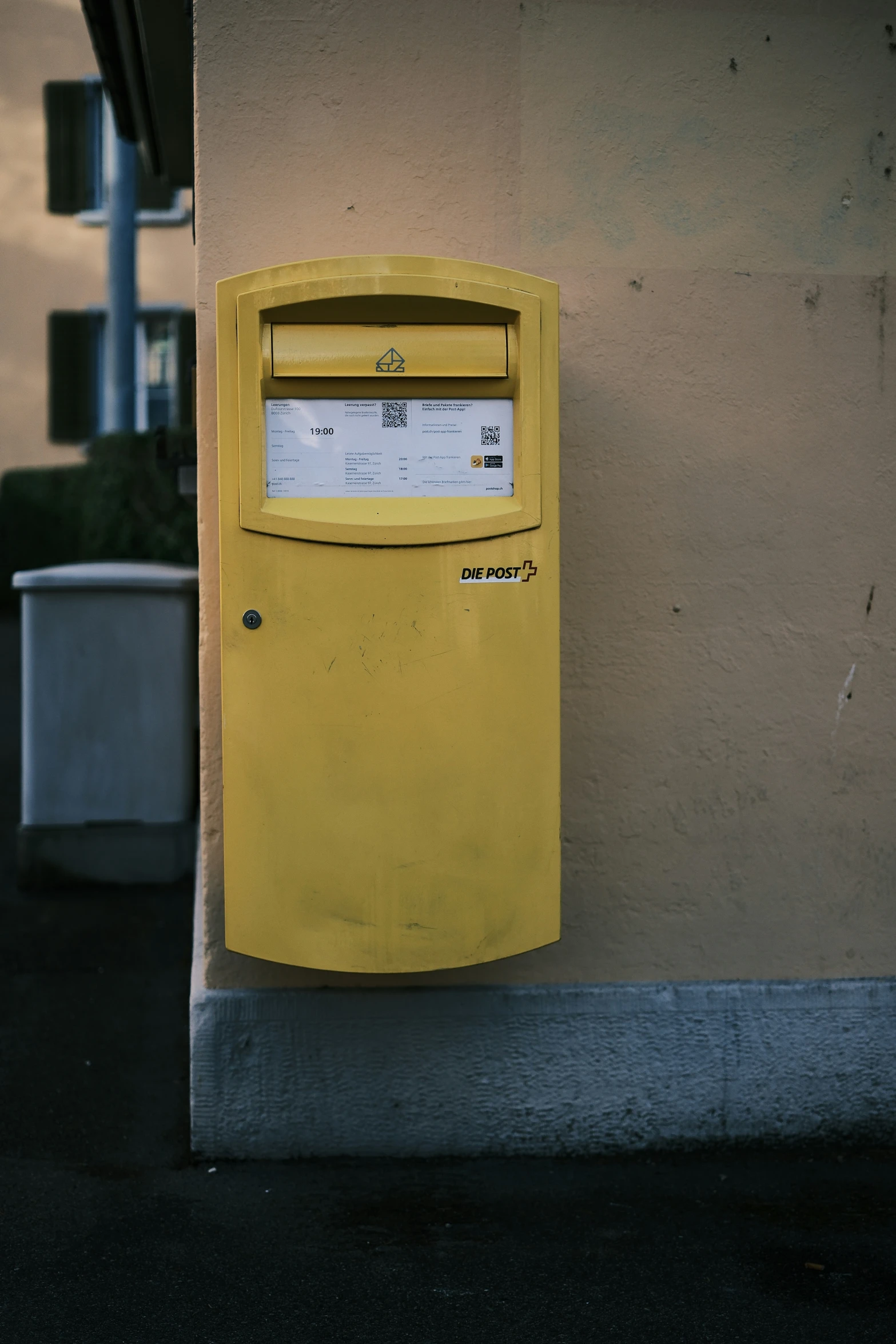 a bright yellow box is attached to the outside of a building