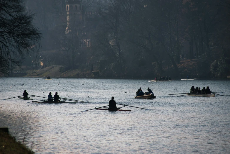 a group of people on boats in the middle of a lake