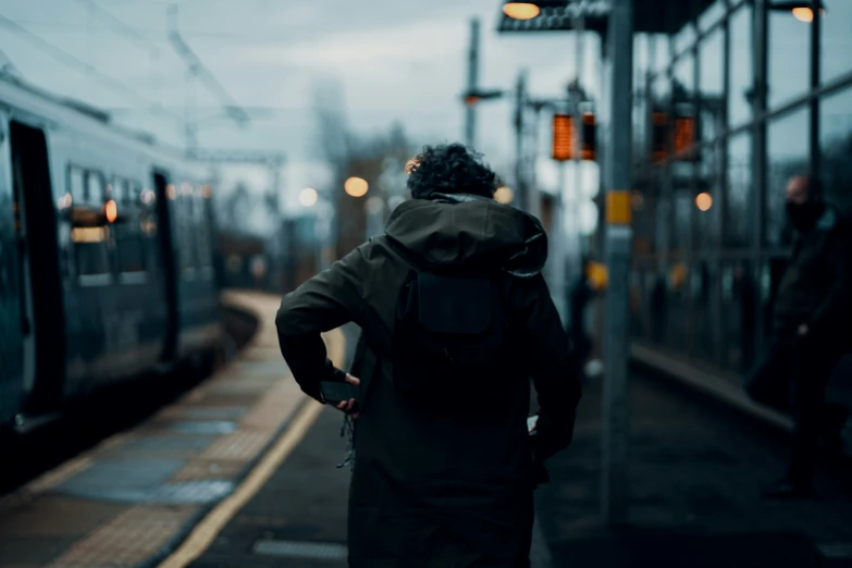 the man is waiting for the train at the station