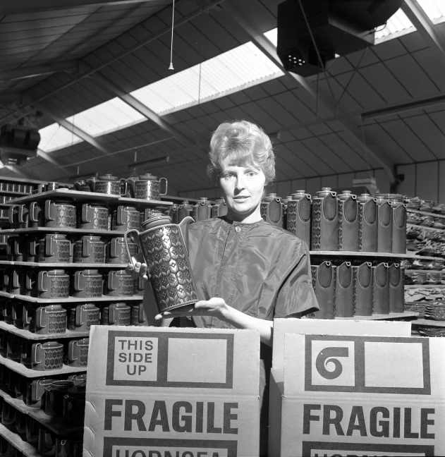 a lady holding two brown boxes in her hands