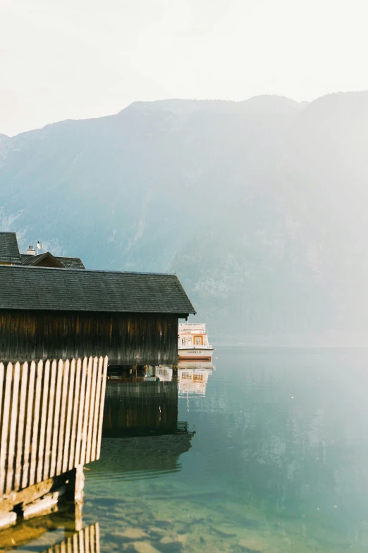 a boathouse with a small boat in it's water