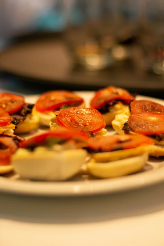 a white plate topped with bacon, tomatoes and potatoes