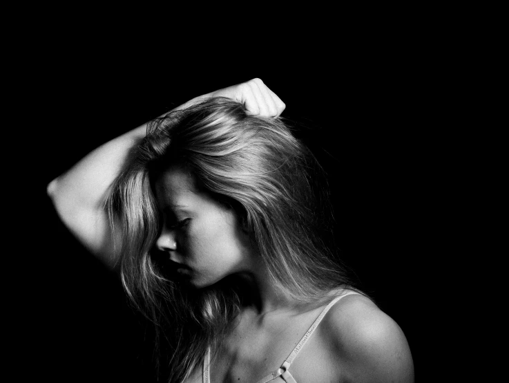 black and white pograph of woman in towel towel wrapped over hair