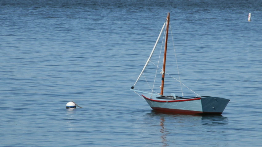 a boat floating in the water, with a life buoy