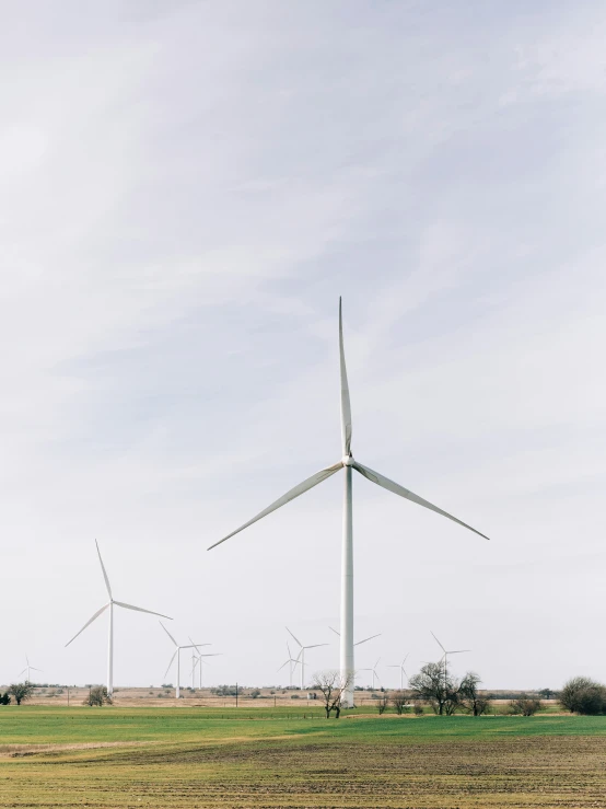 a windmill sitting in a field by itself