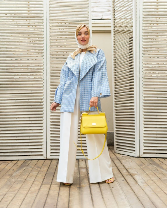 woman posing for a picture with a yellow handbag