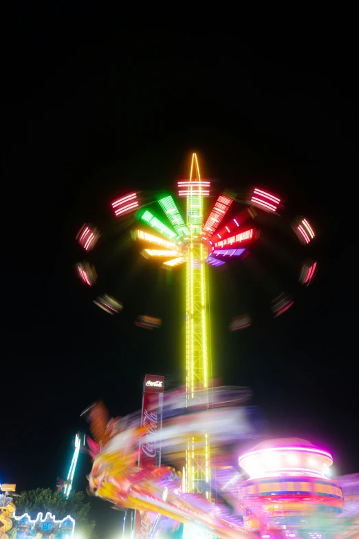 a blurry image of a carousel ride at night