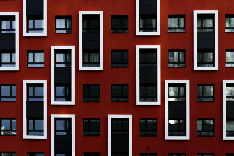 a close up s of windows and doors on a red wall