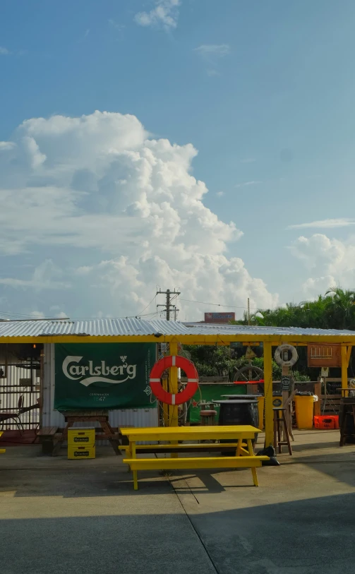 a small restaurant next to the road with some parked cars