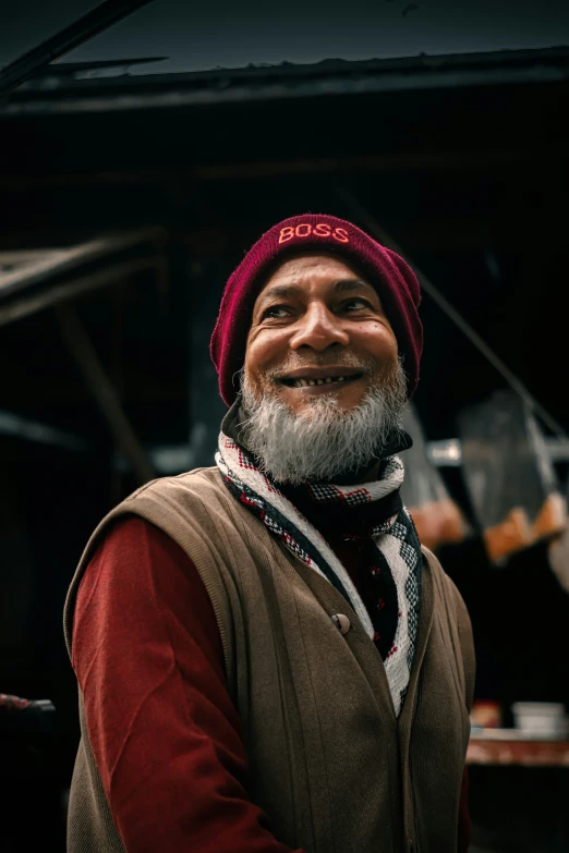 a man is smiling while standing outside