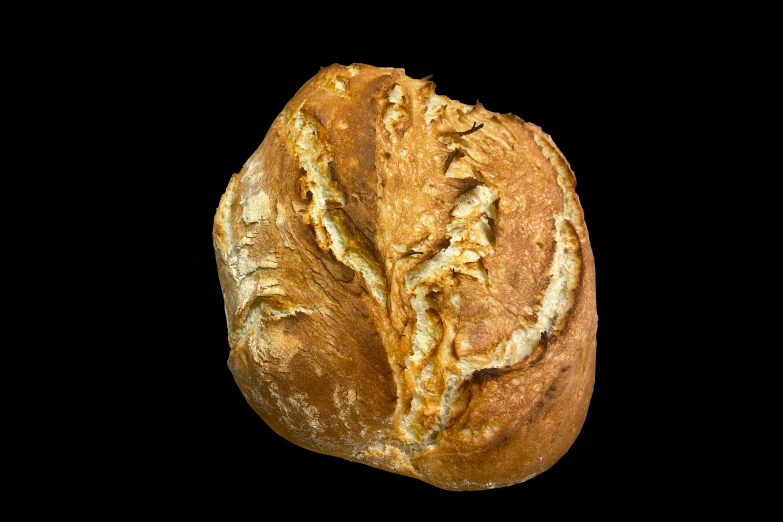 a piece of bread is laying on a black surface