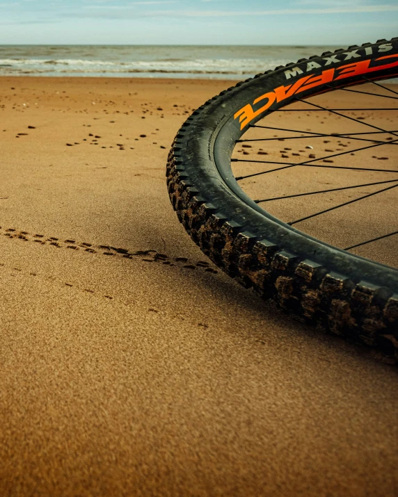 the tire and spokes of a bicycle on a beach