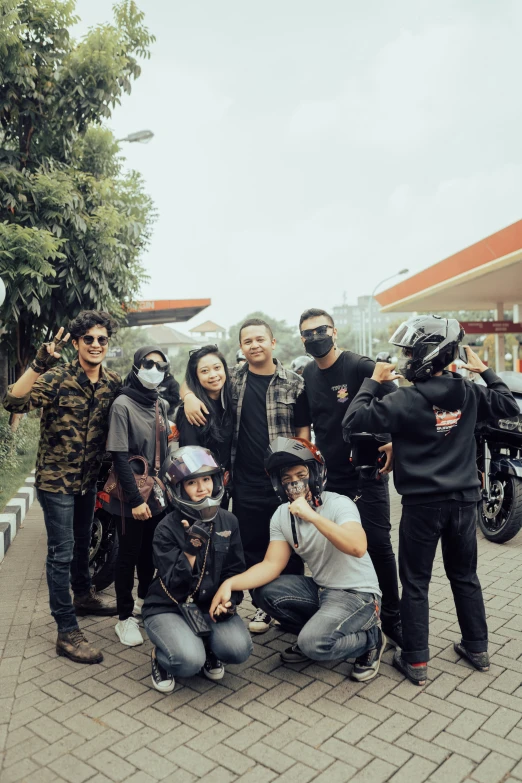 a group of people with masks posing for a po