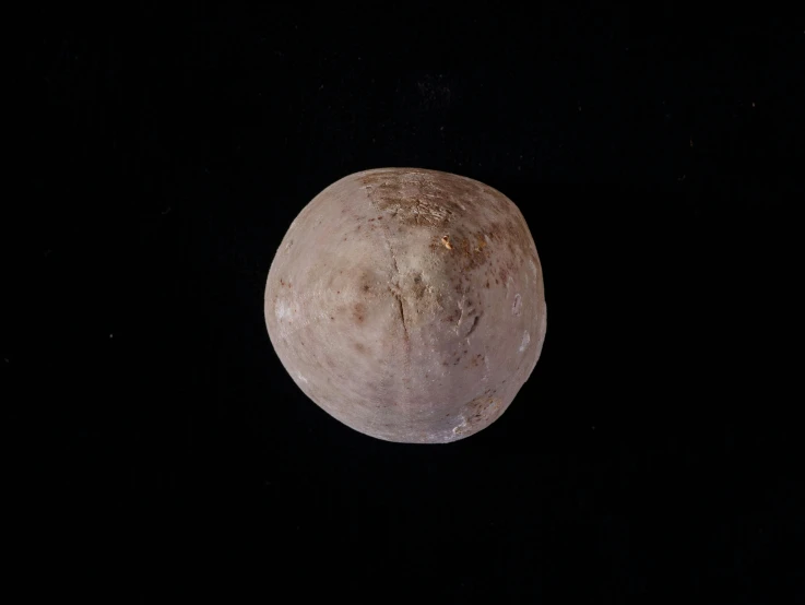 a large piece of pluto's surface with dirty stains on it