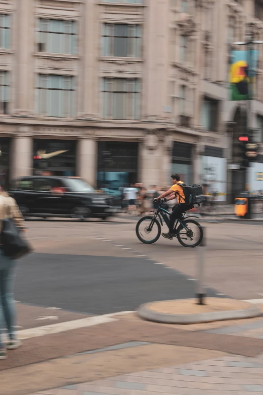 a man riding a bicycle down a city street