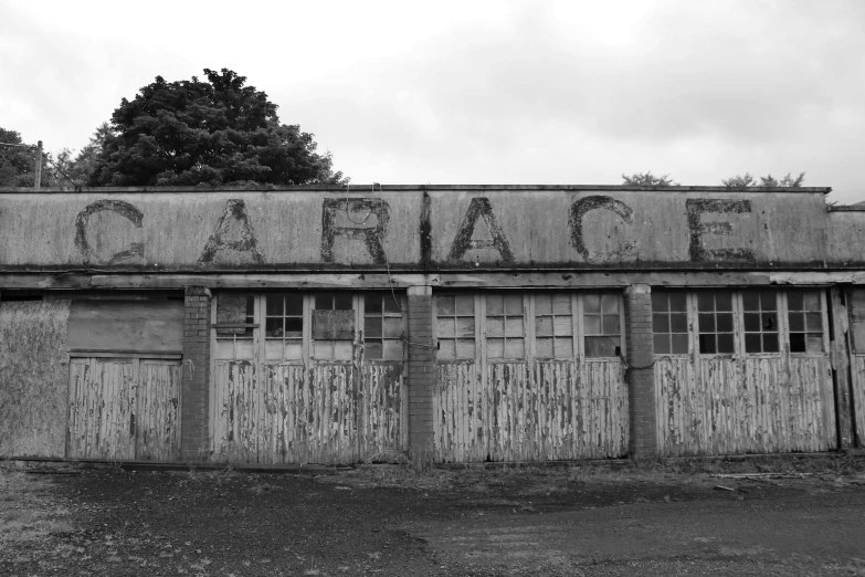 black and white pograph of old building with graffiti on it