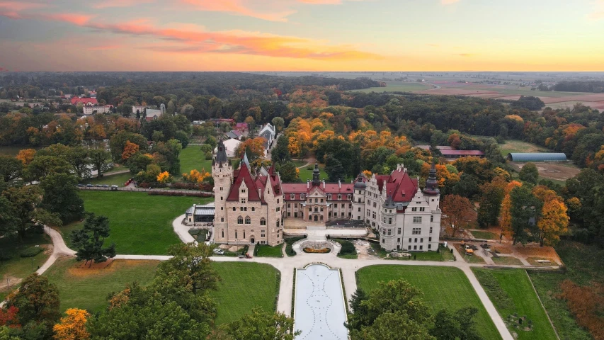 an aerial view of a large building in the woods