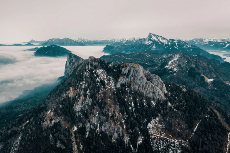 a mountain with several mountains and clouds in the background