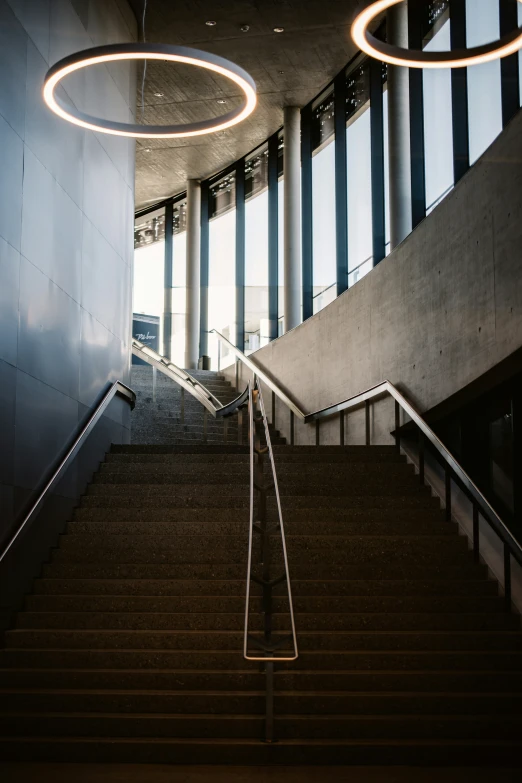 the stair railings are illuminated by round lights