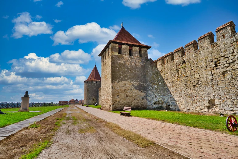 an old cobblestone walkway near a wall