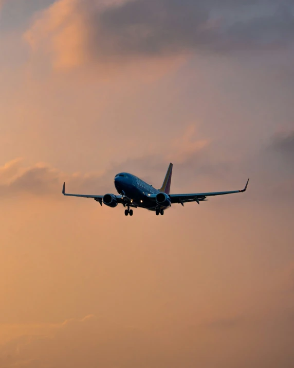 a plane in the sky, just after sunrise