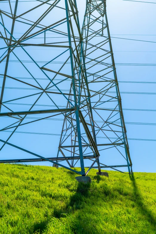 power lines, high up on a hill with a blue sky